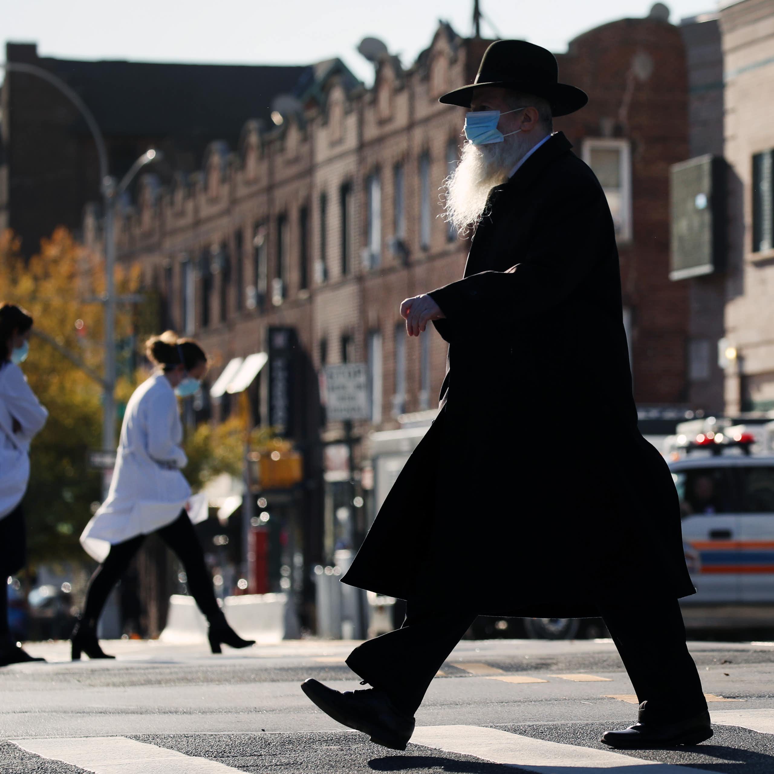 Hasidic man crosses the street in New York City