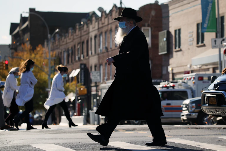 Hasidic man crosses the street in New York City