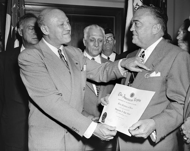 FBI Director J. Edgar Hoover is presented an award in 1953