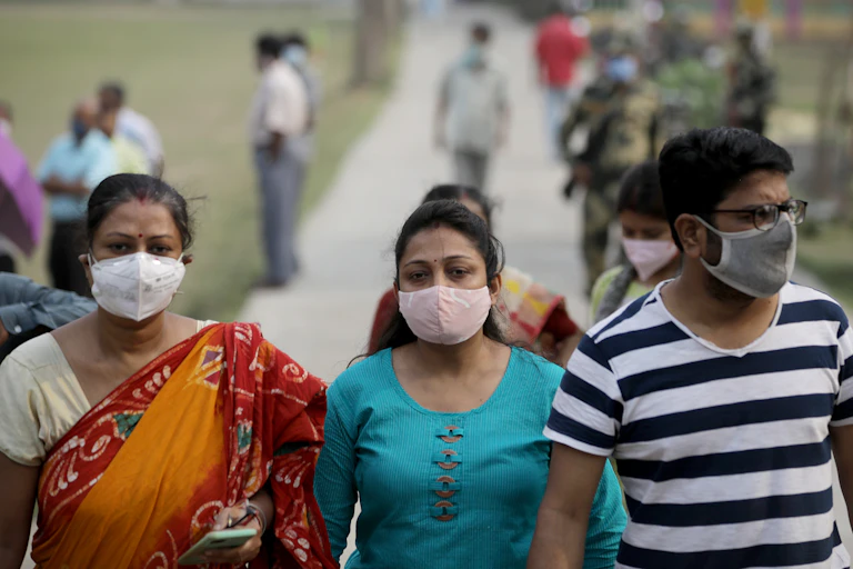 People in India walking outside wearing masks