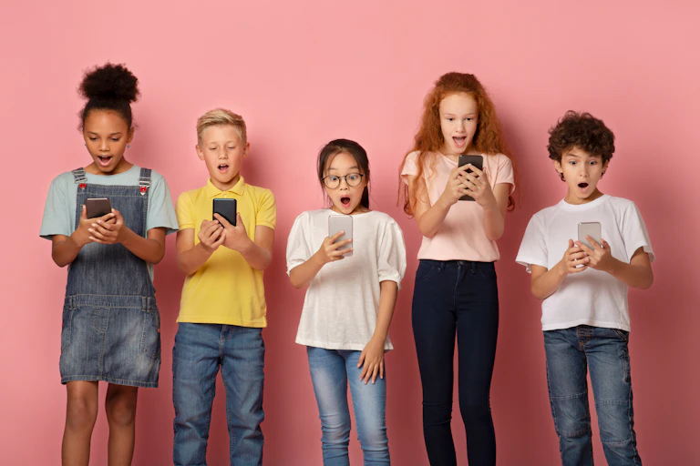 Kids of varying ages on their smartphones.