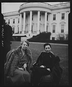 Two women sitting outside.