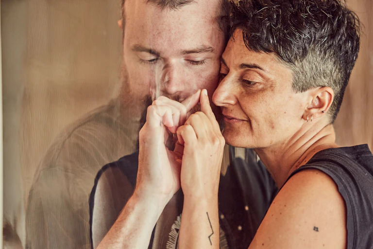 man and woman are close with screen between them