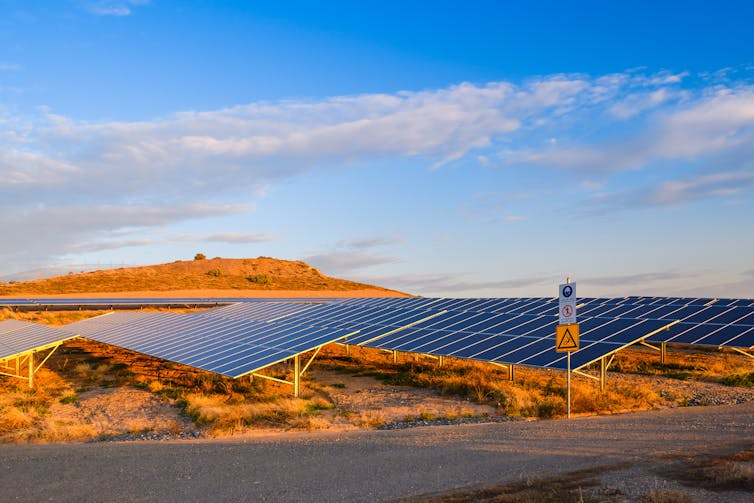 Solar farm in the desert at sunset