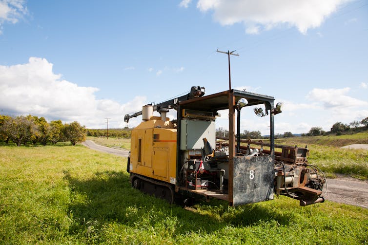 A machine with a large pole in the middle which is driven into the soil before sowing.