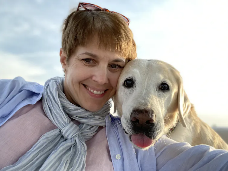 Woman posing for selfie with dog