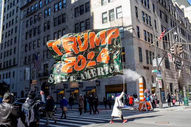 Trump supporters carry a "Trump 2024" banner in New York City.