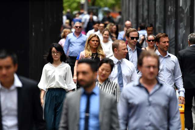 Office workers walking along crowded Sydney street.