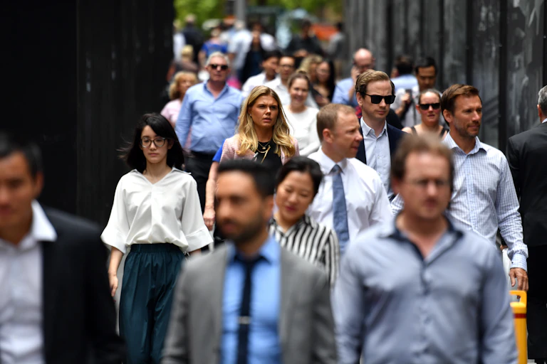 Office workers walking along crowded Sydney street.