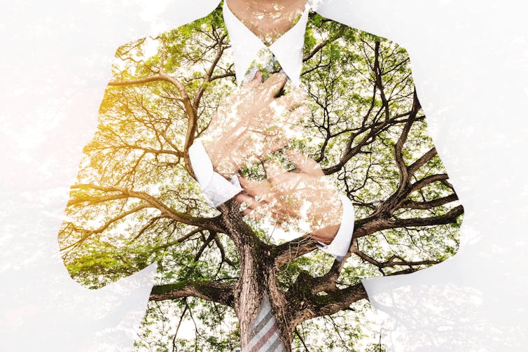 Composite image of man in business suit and tree branches