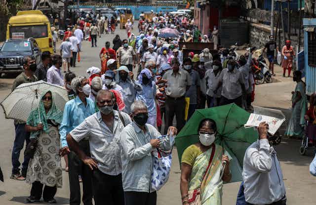 Residents of Mumbai line up for a vaccine.