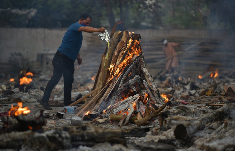 Man burning pyre.