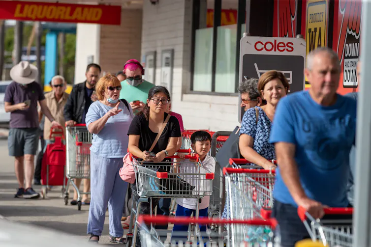 People line up at a shopping centre.