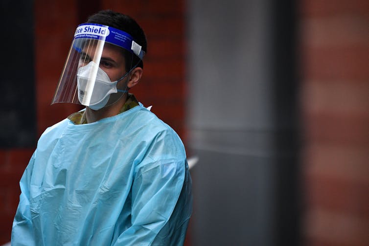 A hotel quarantine worker wearing PPE.