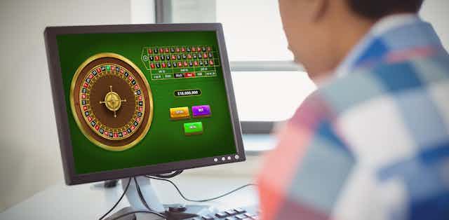 Young person in check shirt gambling online