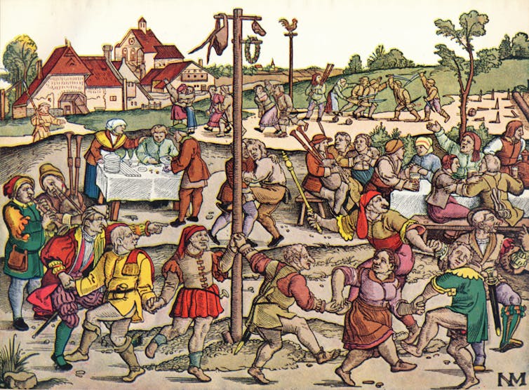 Revelers dance around a maypole in Germany in the 16th century.