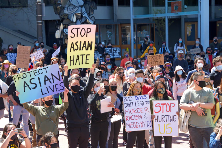 Protesters hold signs