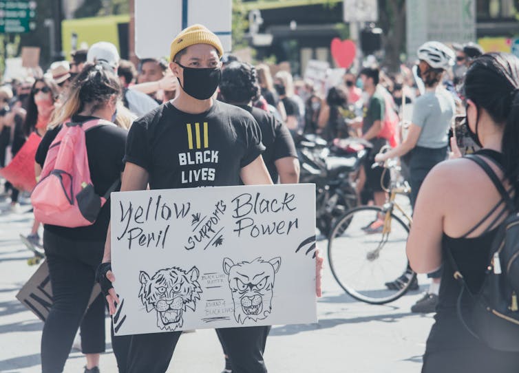 Man holding protest sign