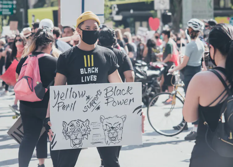 Man holding protest sign