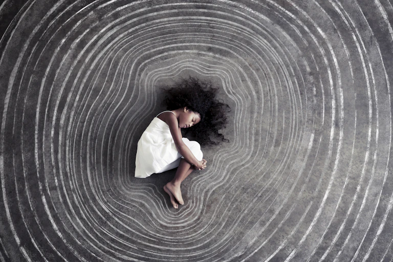 Young girl sleeps surrounded by concentric chalk outlines of her body.