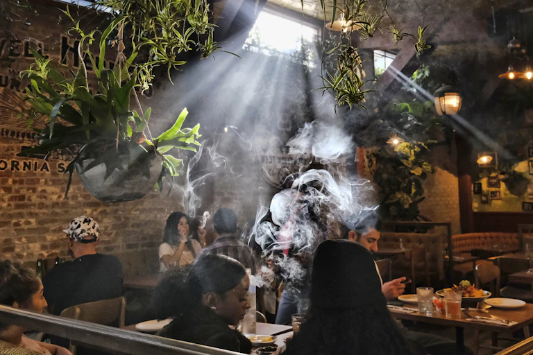 People smoke marijuana in a legal cannabis cafe.