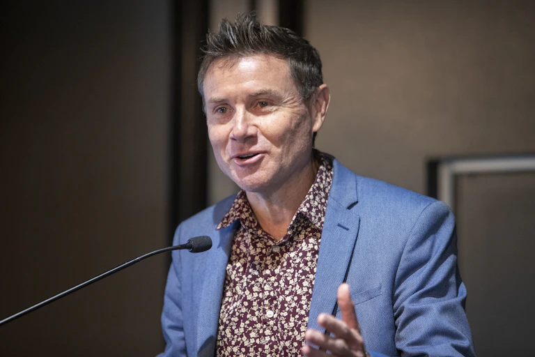 Andrew Laming speaking into a microphone.