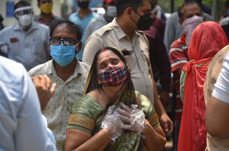 Family members outside a mortuary in New Delhi.