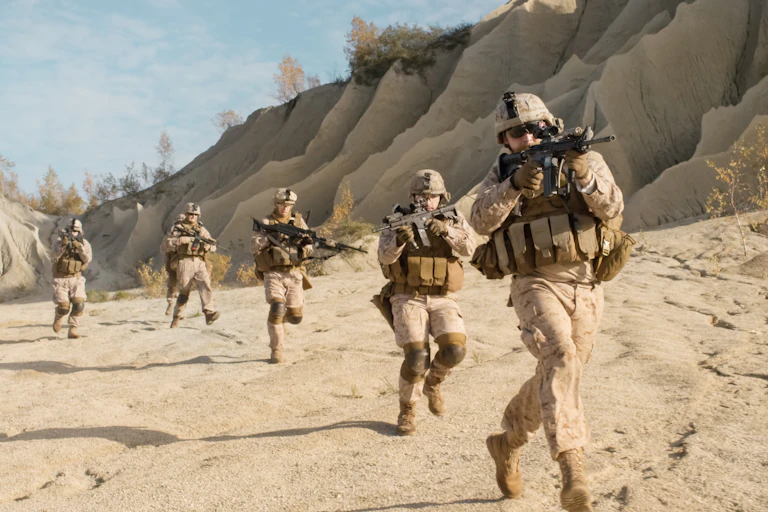 Image of a group of soldiers running through the desert.