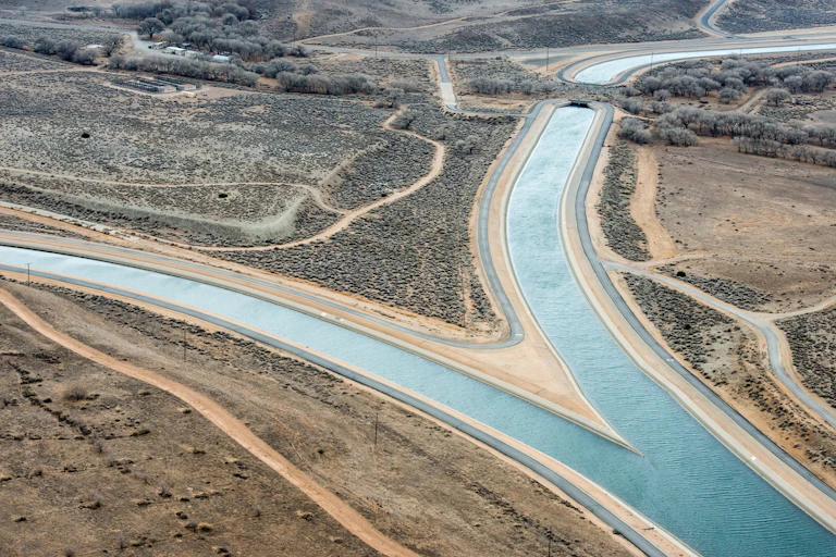 A canal filled with water divides into two branches.