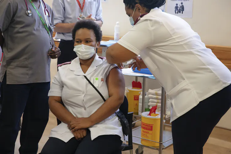 A health worker being vaccinated