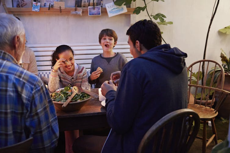 multigenerational family eating a meal at the table