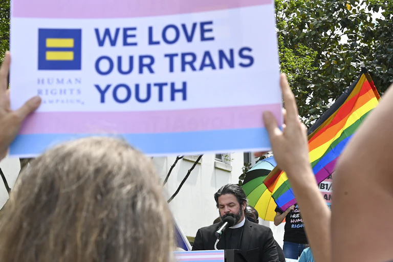 "We love our Trans Youth" sign held aloft at a rally to protest anti-transgender legislation introduced in Alabama.