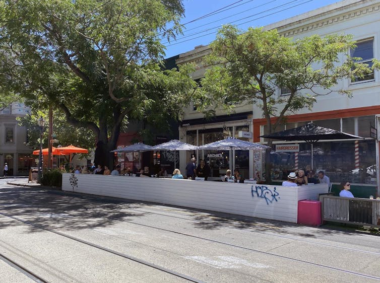 a streetside parklet set up for outdoor dining