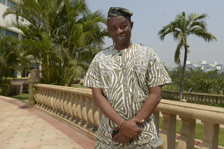 A man standing and smiling for a photo.