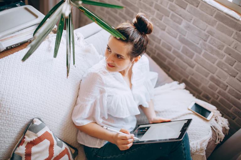 Woman working at home with a tablet