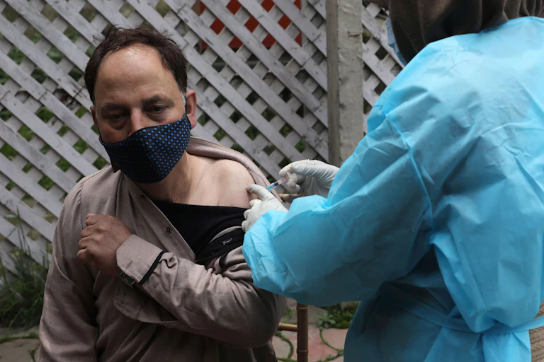 An Indian man being vaccinated for COVID-19