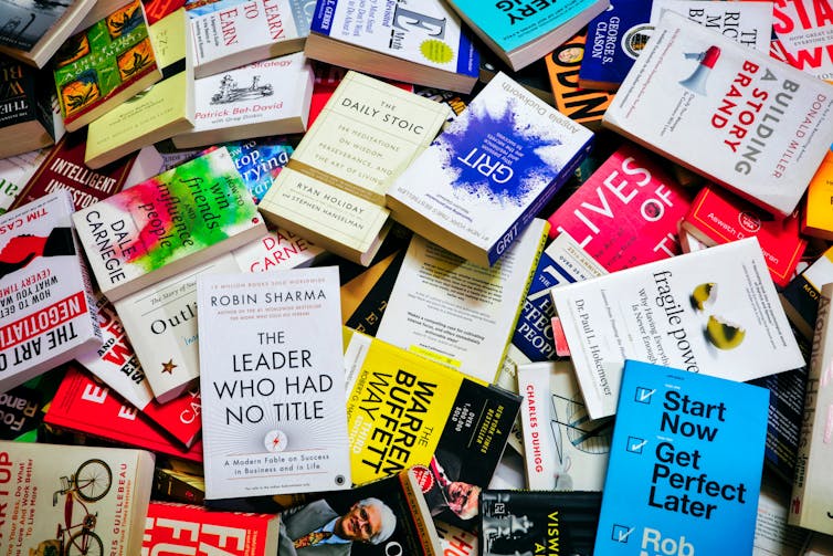 A messy pile of self-help books.