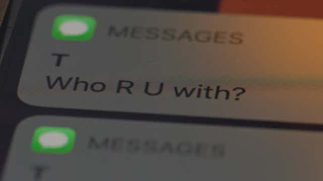 Text message saying 'Who R U with?'