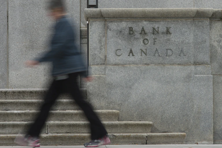 A woman walks past the Bank of Canada