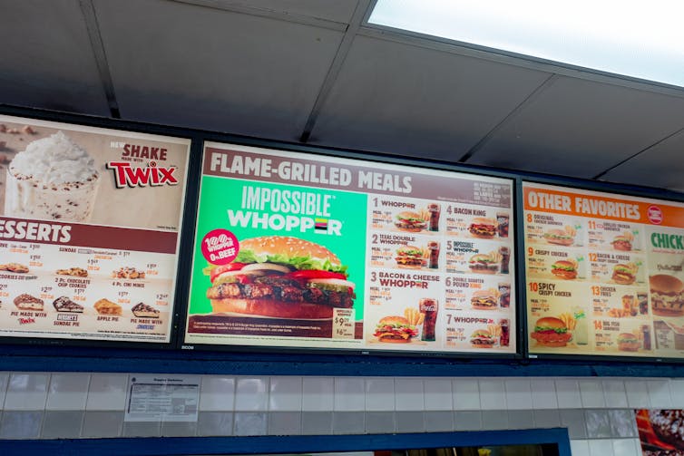 Close-up of Burger King menu board with advertisement for the Impossible Whopper