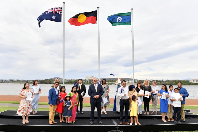 Prime Minister Scott Morrison with new citizens at an Australia Day ceremony in Canberra.