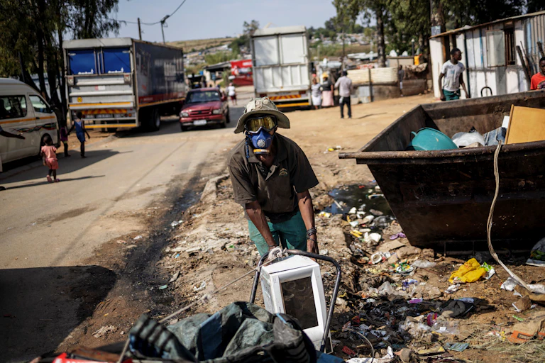 Waste reclaimer picking up waste.
