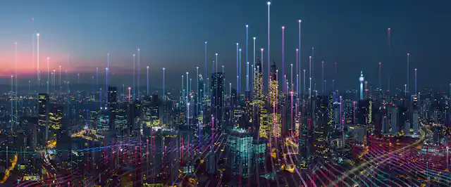 A photo of a city at night time with streaks of light coming out of each skyscraper.