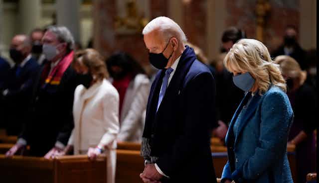 Joe Biden and his wife Jill Biden attending mass in church.