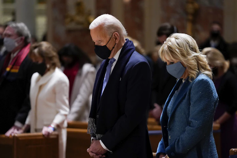 Joe Biden and his wife Jill Biden attending mass in church.