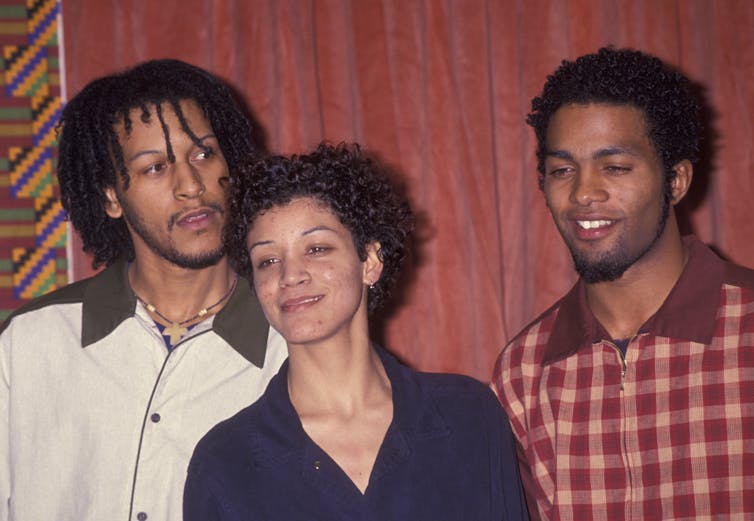 Três artistas de hip-hop estão juntos posando para uma foto.