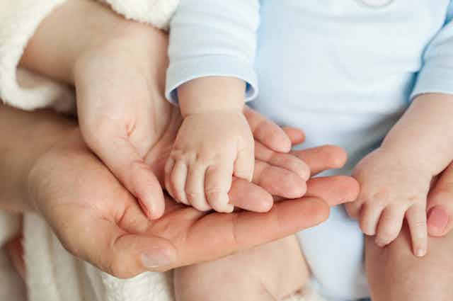 Mother and father and baby's hands