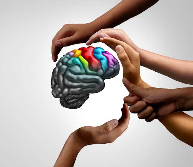 A brain surrounded by supportive hands
