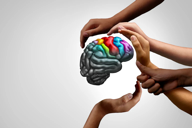 A brain surrounded by supportive hands