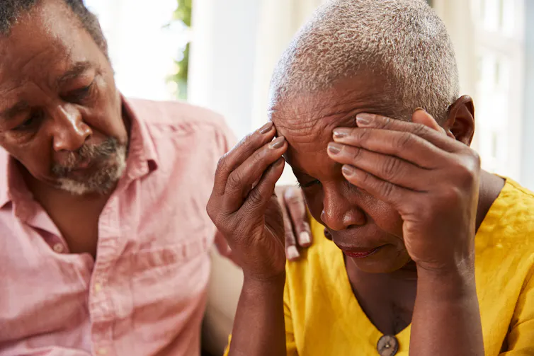 A concerned older man and a distraught older woman